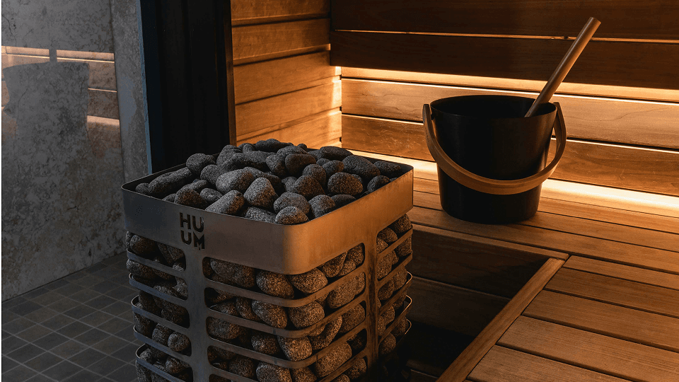 The Alpirious sauna with a lava-rock heater and wooden benches