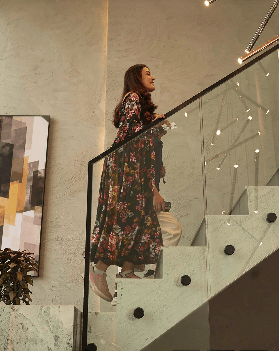 A guest ascending the sculptural Alpirious staircase