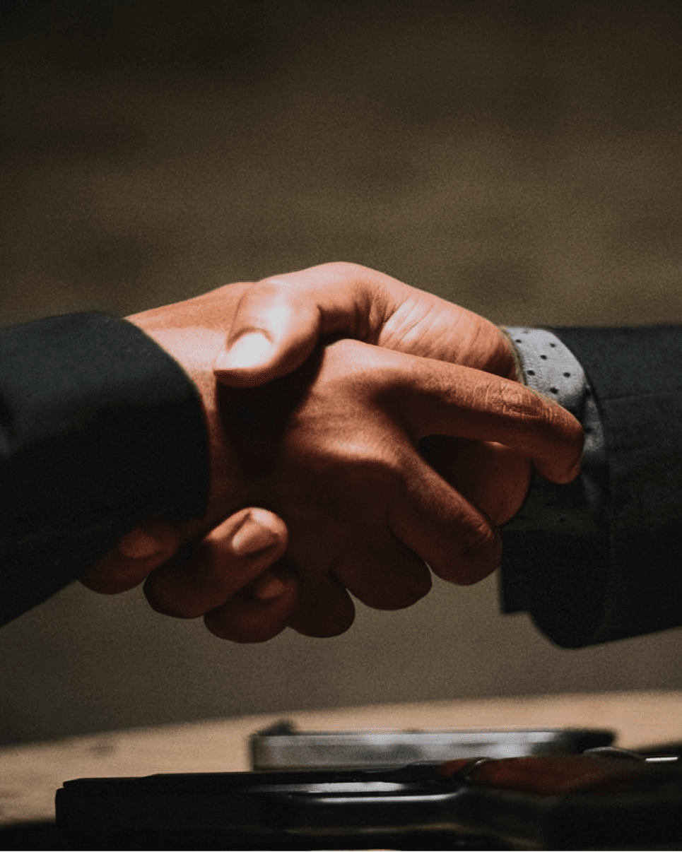 Two professionals shaking hands to close a deal