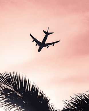 A plane crossing a sunset sky